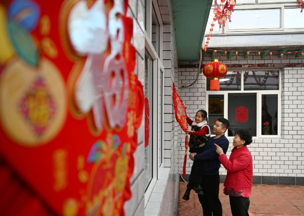 在天津市西青区辛口镇第六埠村，村民在院子里挂“福”字（2024年2月1日摄）。新华社记者 赵子硕 摄